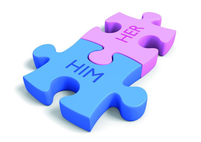 Matchmaking concept of puzzle pieces with the words him and her